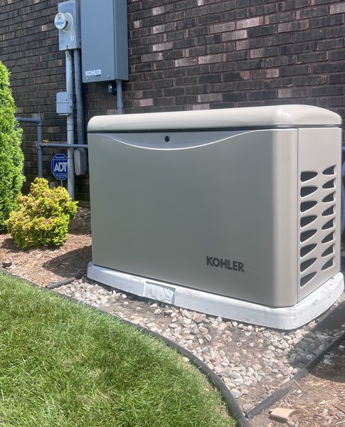 Kohler home standby generator installed by American Generator Solutions at a brick home